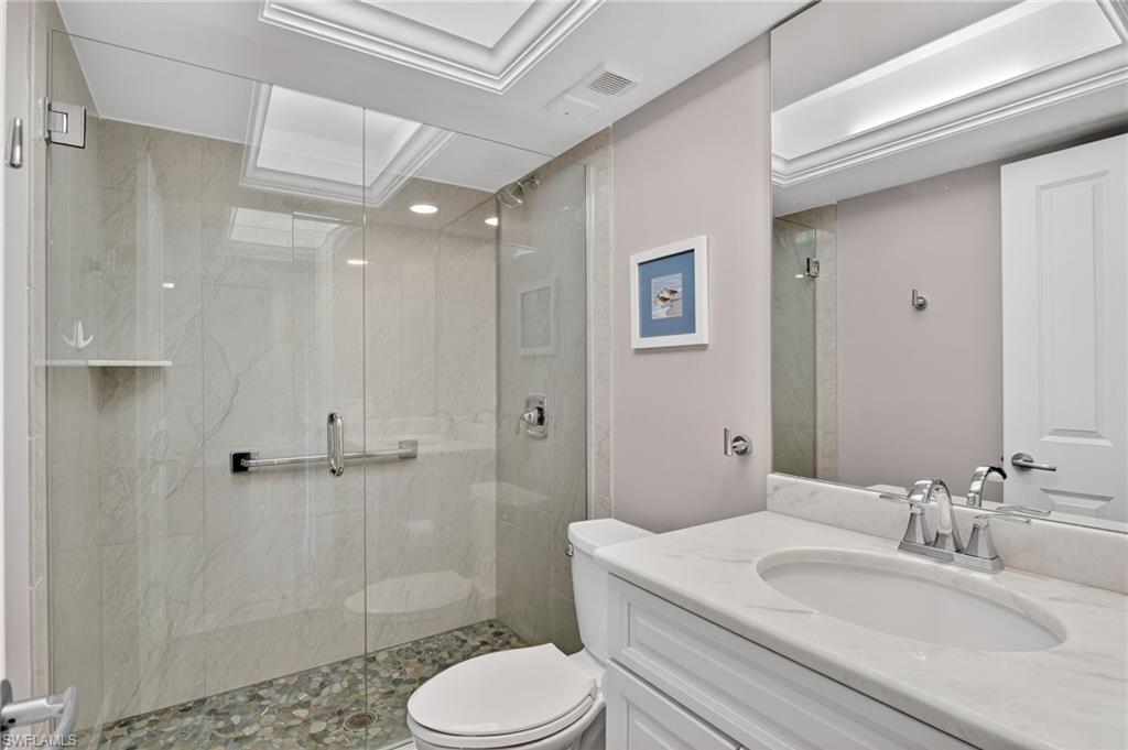 Full bathroom with vanity and a marble finish shower