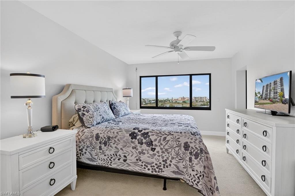Bedroom featuring light colored carpet and ceiling fan