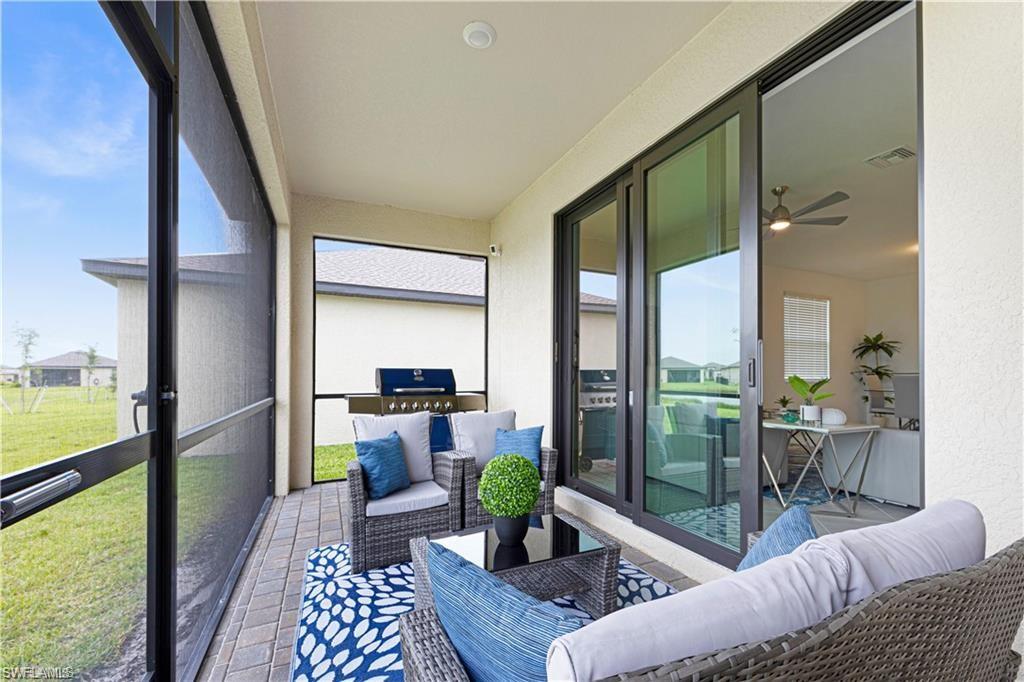 Sunroom / solarium with a ceiling fan and outdoor lounge area