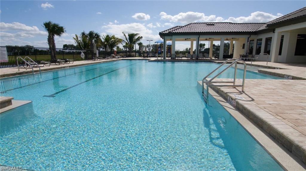 Community pool with a patio