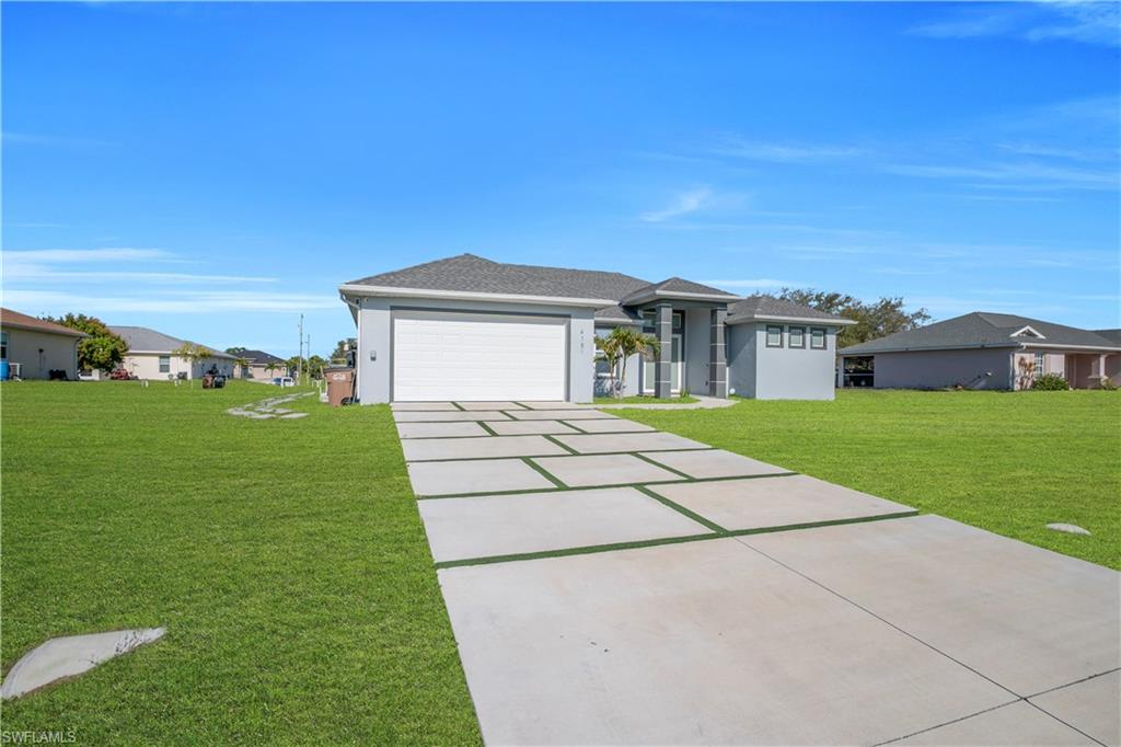 Prairie-style house with a front lawn, concrete driveway, a residential view, and a garage