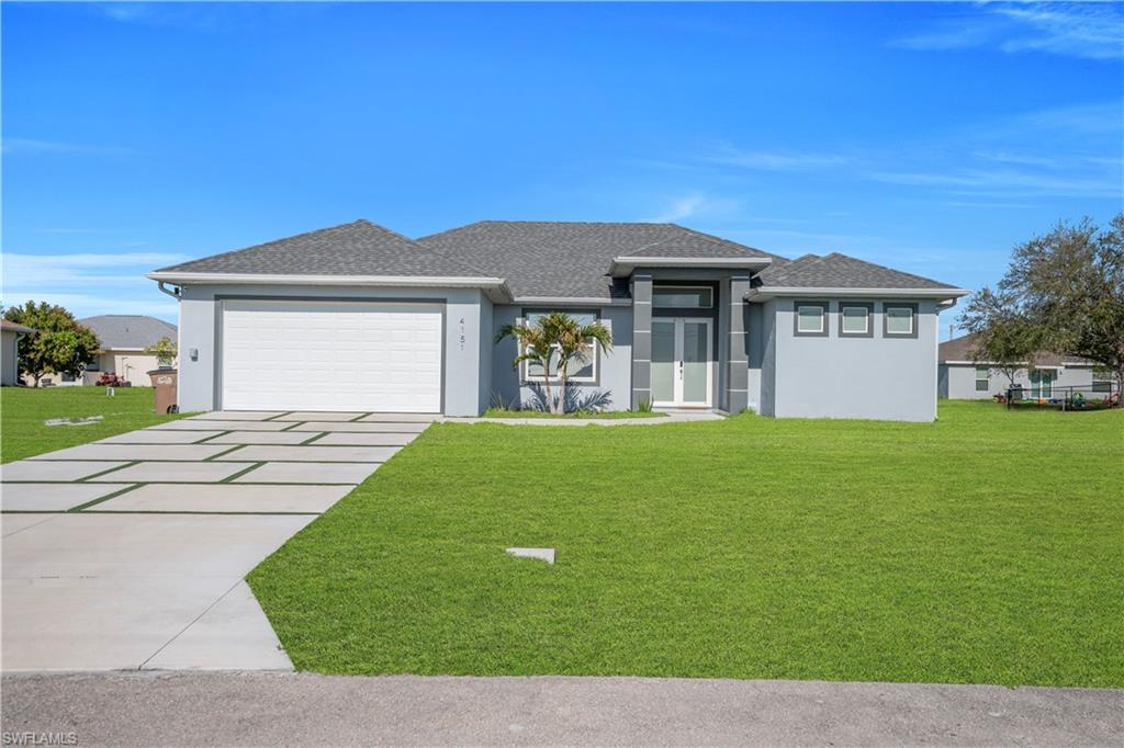 Prairie-style house with stucco siding, roof with shingles, driveway, a garage, and a front lawn