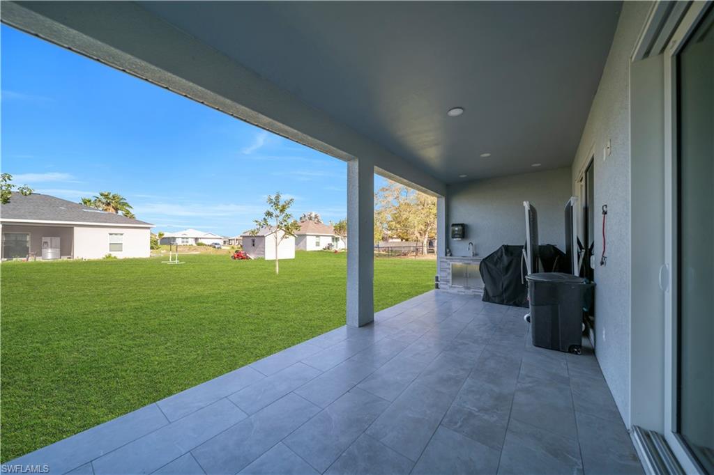 View of patio / terrace with a residential view and a grill