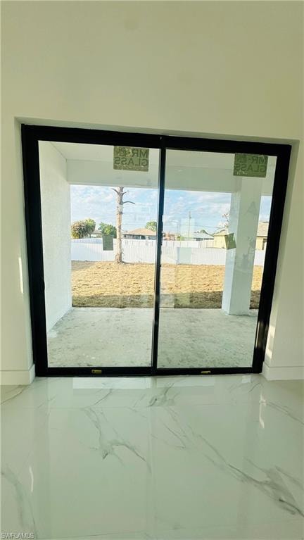 Doorway to outside featuring baseboards