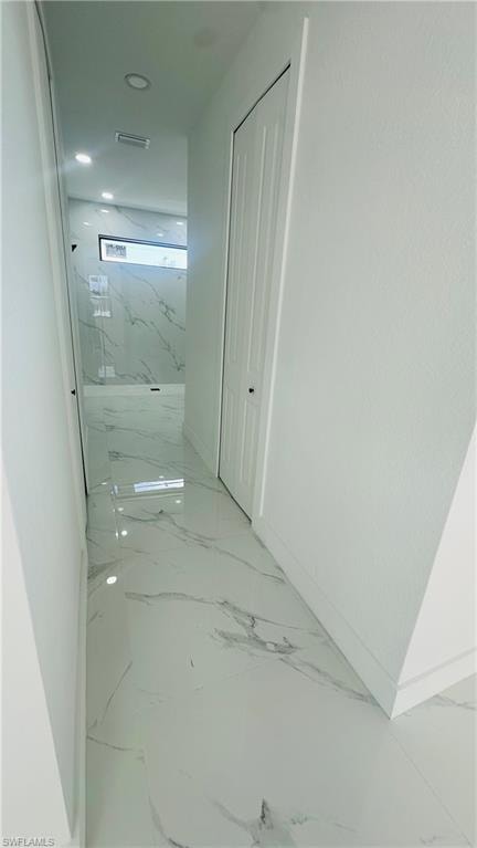 Corridor with baseboards and light marble finish flooring