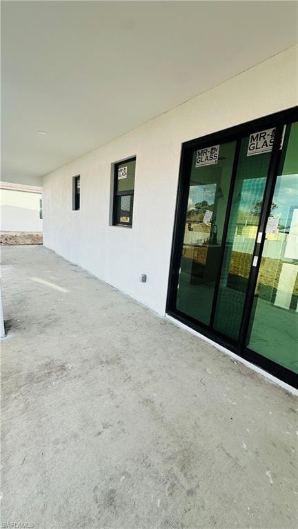 Entrance to property featuring stucco siding