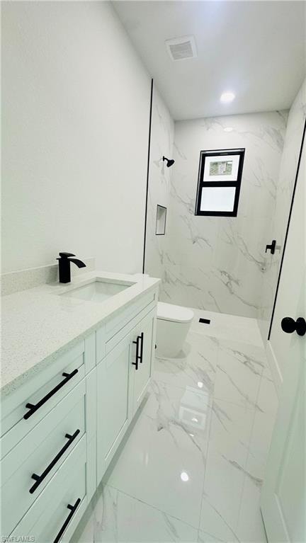 Full bath featuring vanity and a marble finish shower