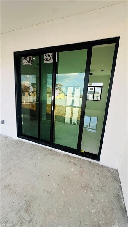 Property entrance with stucco siding
