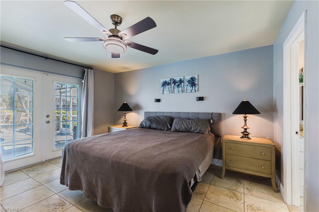 Bedroom with access to exterior, ceiling fan, and french doors