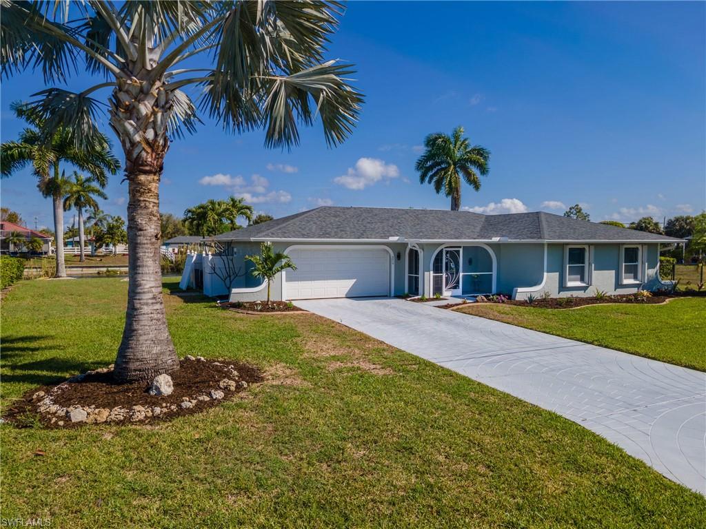 Front view of the  home featuring attached garage, concrete driveway and beautiful front yard.