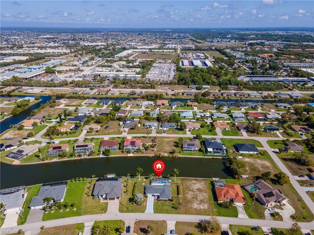Aerial overview of property's location featuring nearby suburban area and a nearby body of water