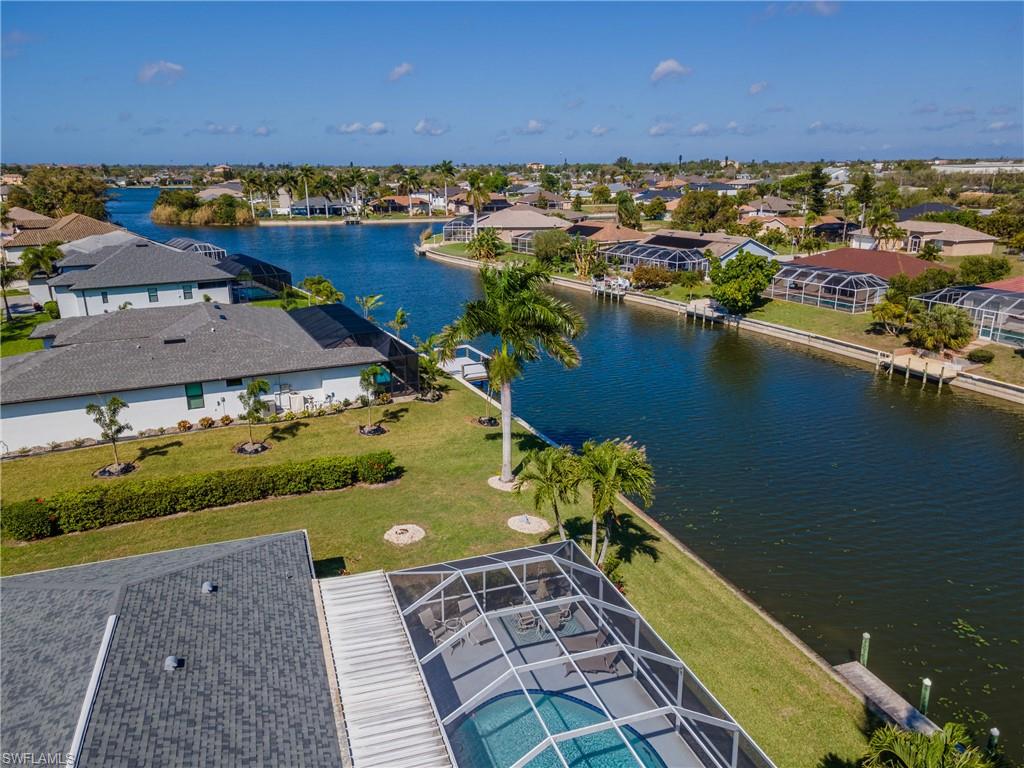 Aerial perspective of suburban area with a nearby body of water