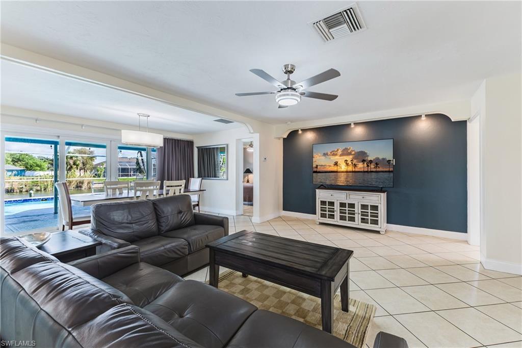 Spacious living room and dining room with view to the outside swimming pool