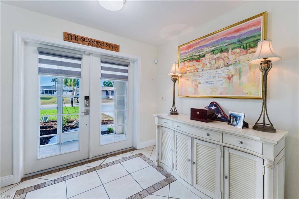 Doorway featuring tile patterned flooring and french doors