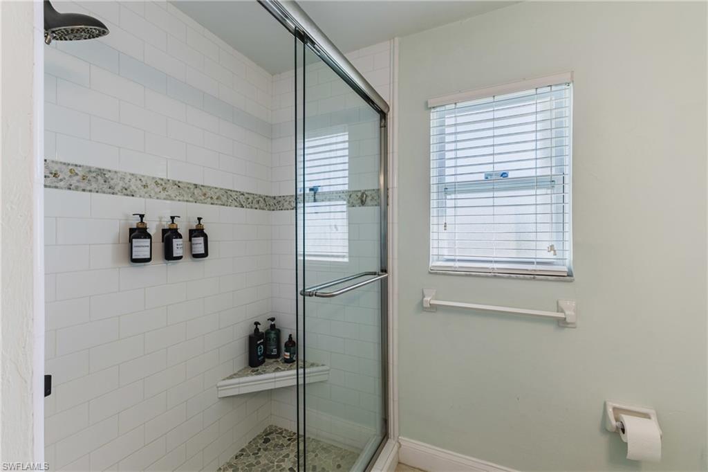 Full bathroom with a shower stall