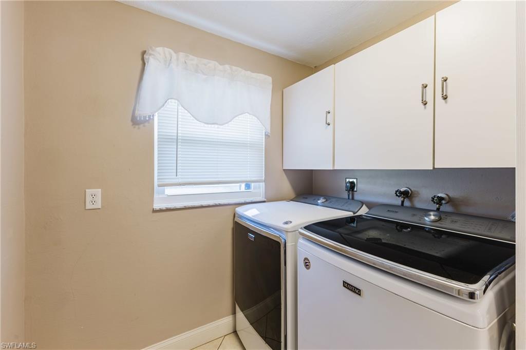 Laundry area with cabinet space and washer and dryer