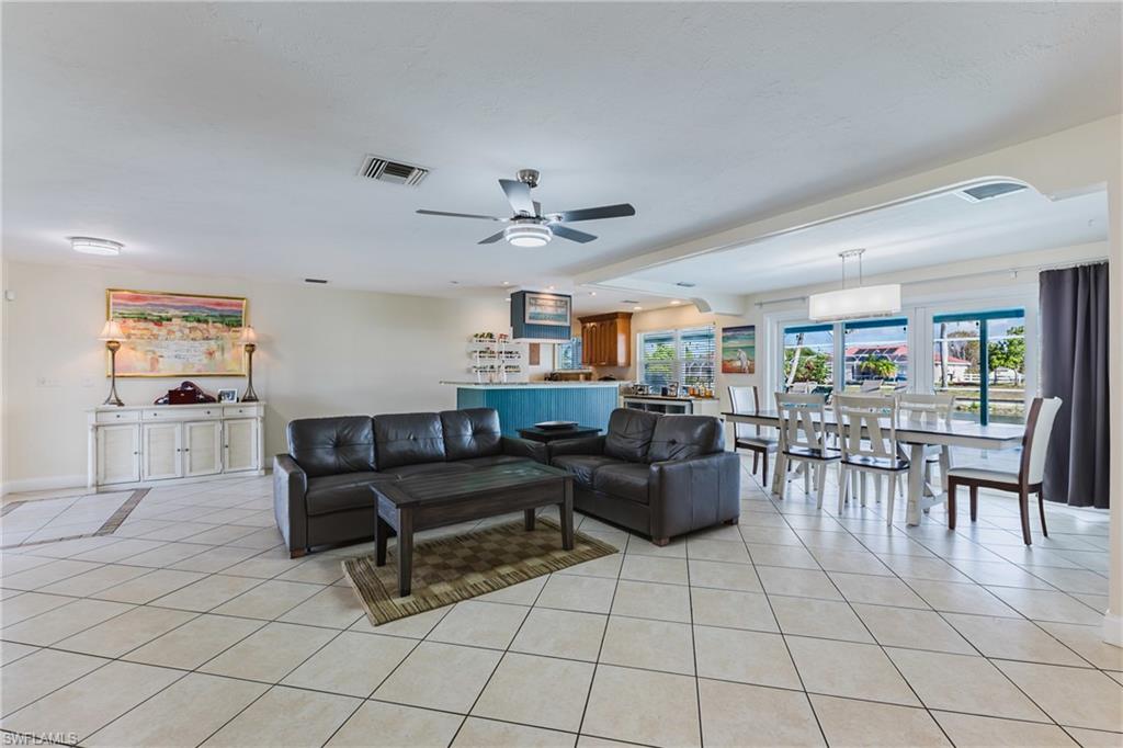 Bright and inviting open-concept layout seamlessly connecting the living room, dining area, and kitchen.