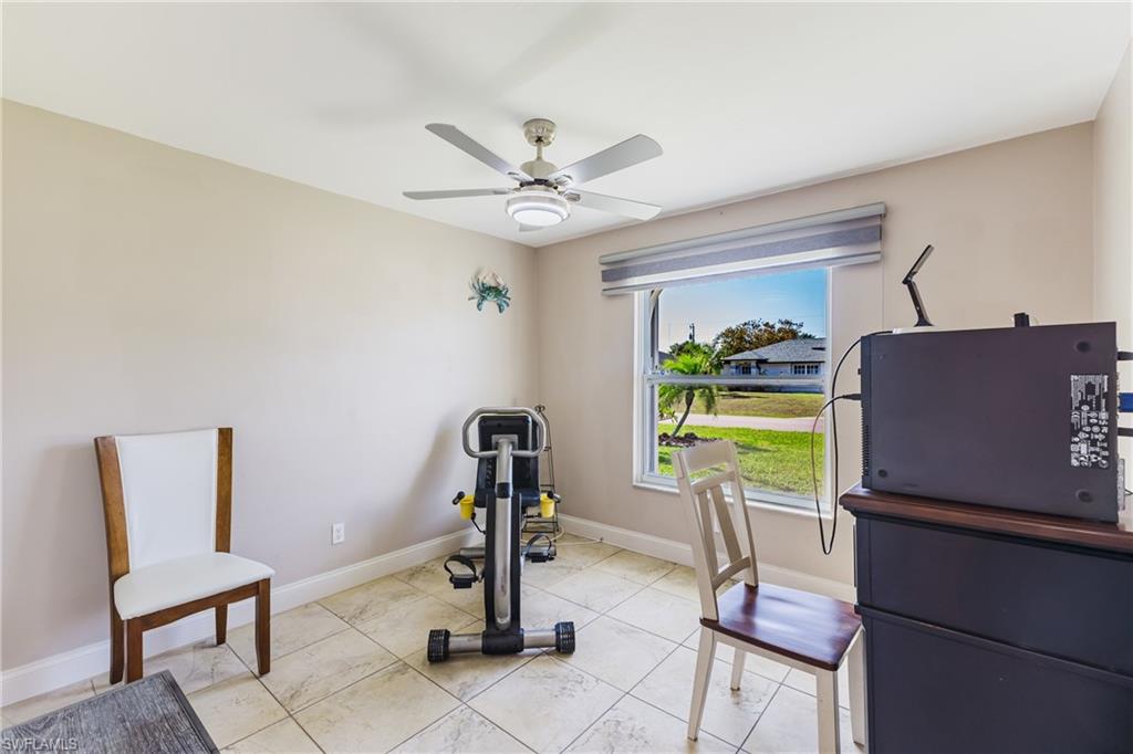 Workout room featuring baseboards and a ceiling fan