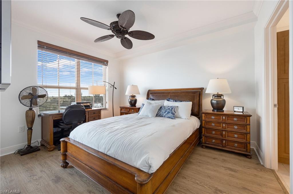 Bedroom featuring crown molding, light hardwood / wood-style flooring, and ceiling fan