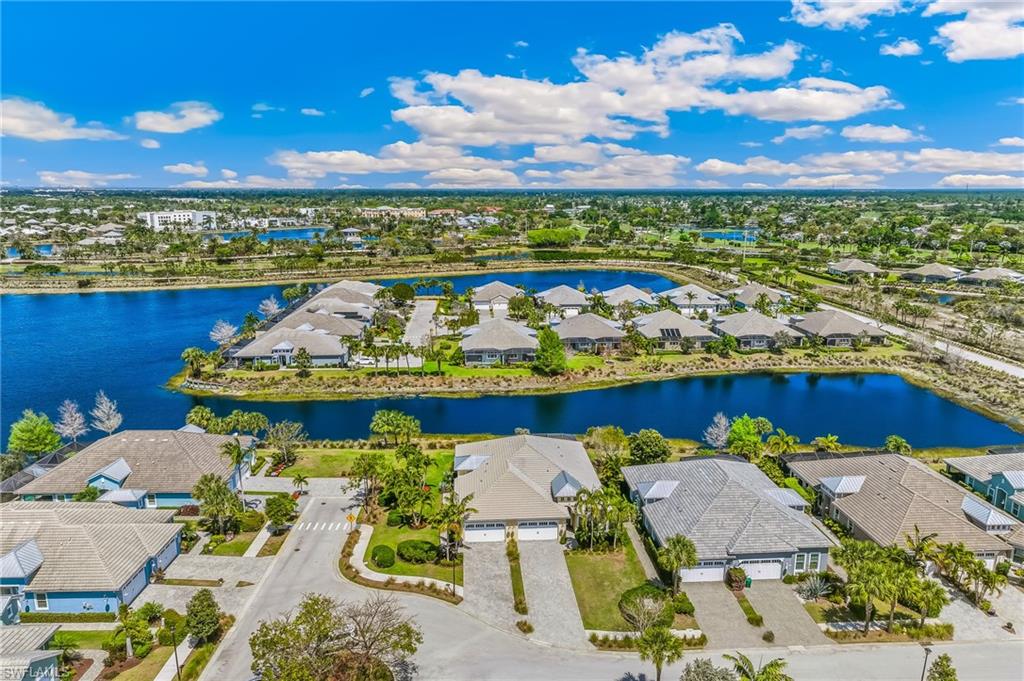 Aerial perspective of suburban area featuring a nearby body of water