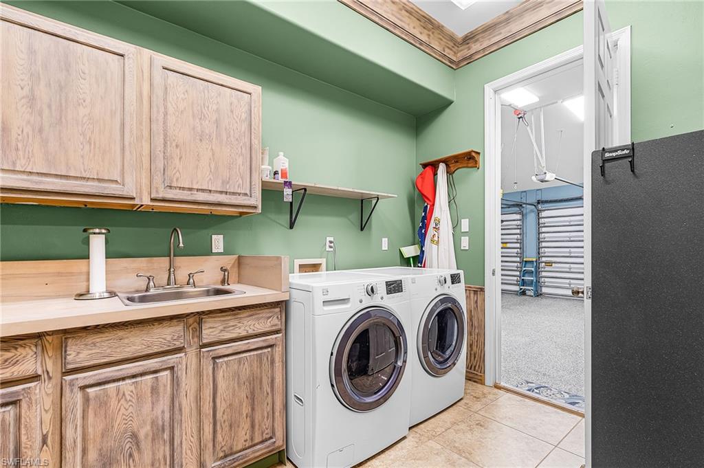 Laundry room, cabinet, sink, washer and propane dryer