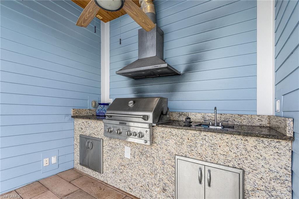 Screen back patio with outdoor kitchen and sink