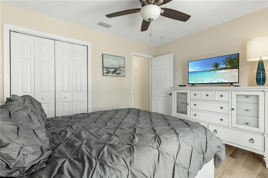 Bedroom featuring wood finish floors, a ceiling fan, and a closet