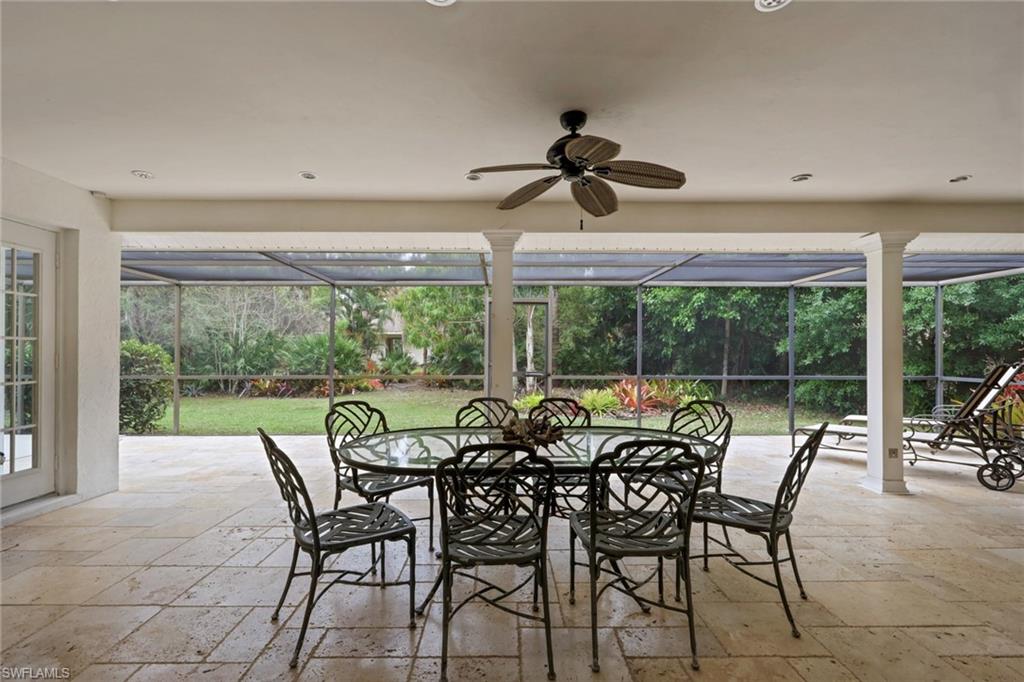 View of patio from great room with outdoor dining area, a lanai, and ceiling fan, recessed lighting, travertine tileflooring.