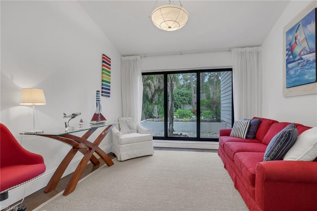 Third Bedroom /Den vaulted ceilings, 7-inch baseboards, new impact sliding window, polished concrete floors, closet. looks out to the street