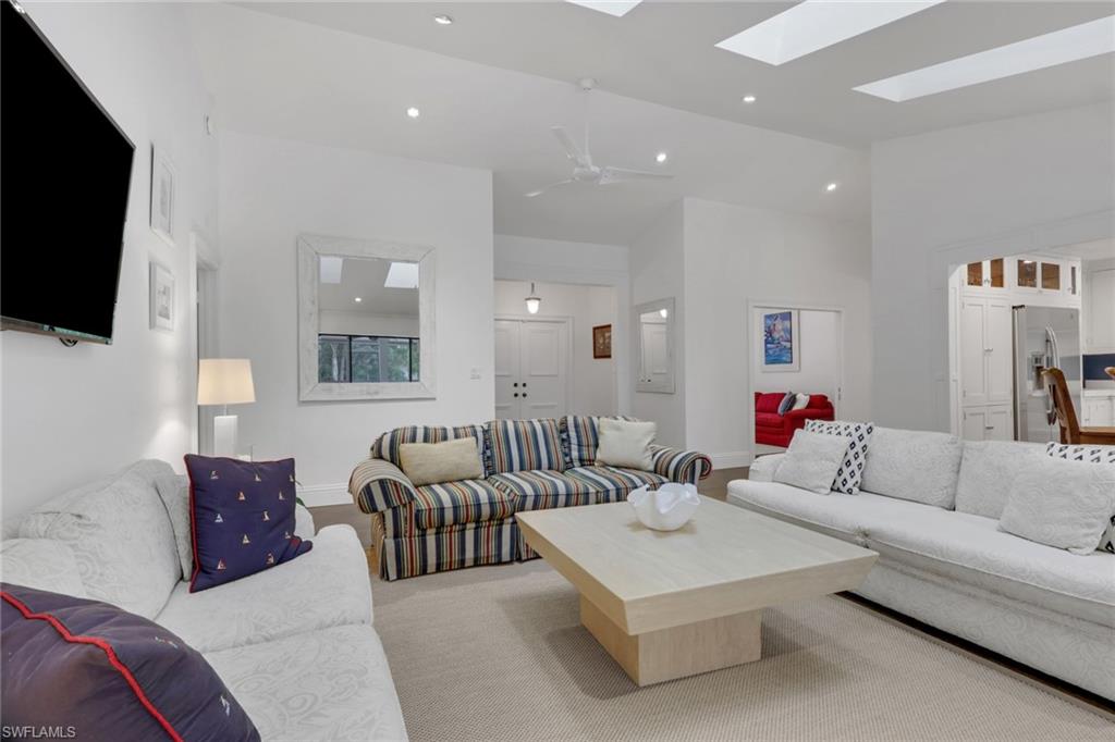Great Room featuring recessed lighting, a ceiling fan, a skylight, and a high ceiling