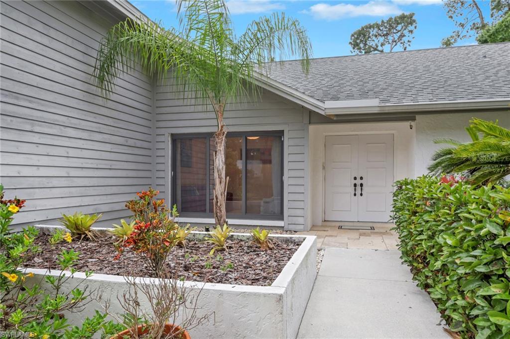 Property entrance featuring roof with shingles