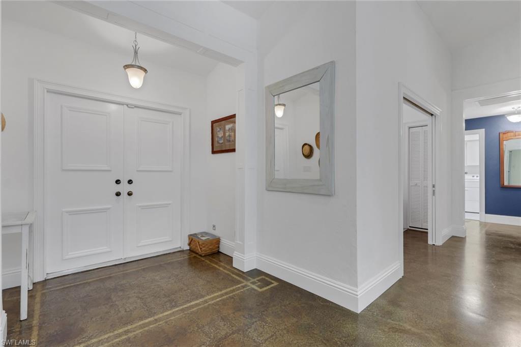 Entryway with polished concrete flooring and vaulted ceiling