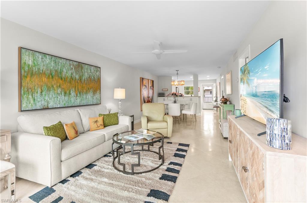 Living room with a ceiling fan and hanging lights