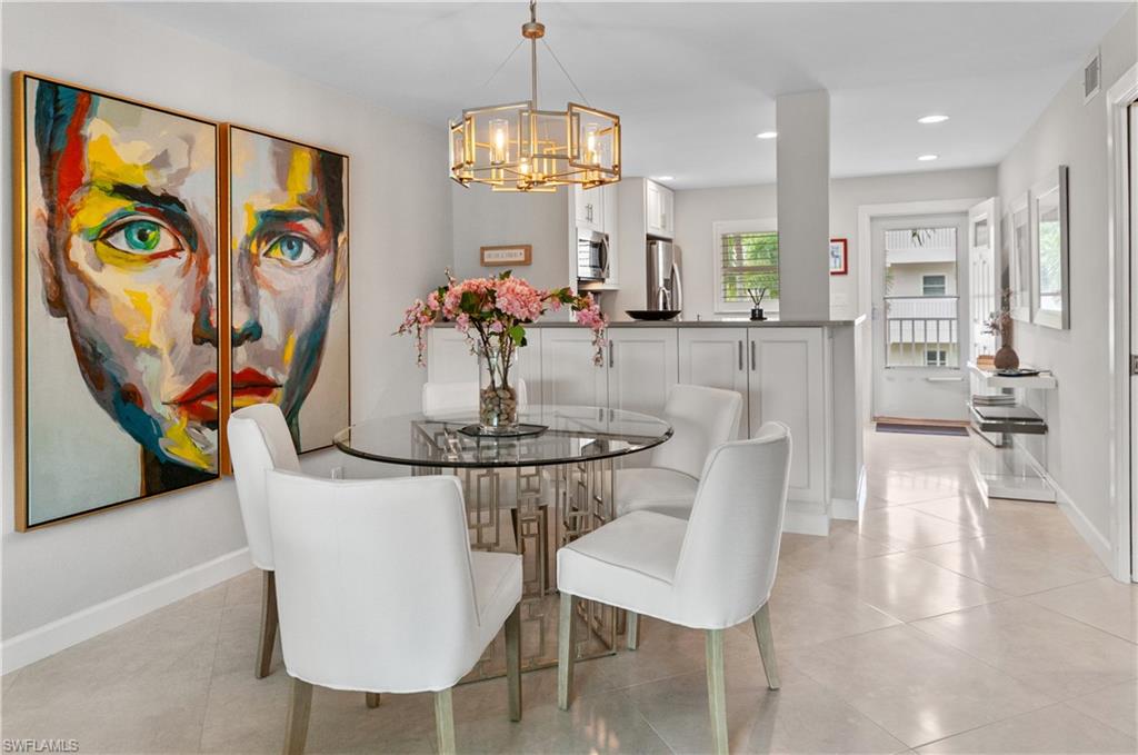Dining room featuring suspended lighting and light tile patterned floors