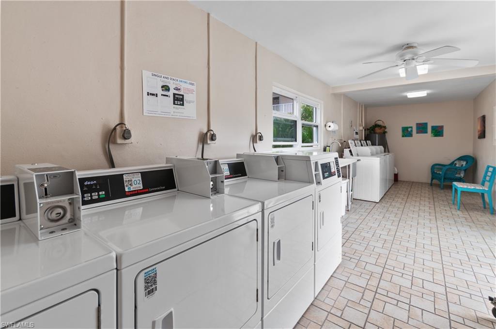 Communal laundry room featuring washing machine and clothes dryer and a ceiling fan