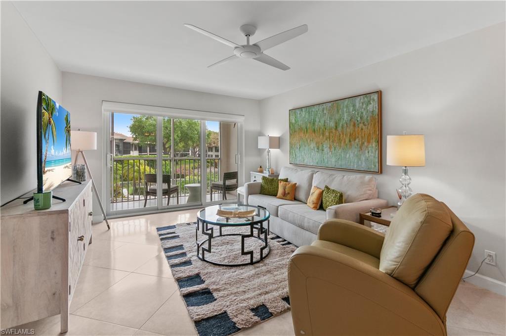 Living area with a ceiling fan and light tile patterned floors