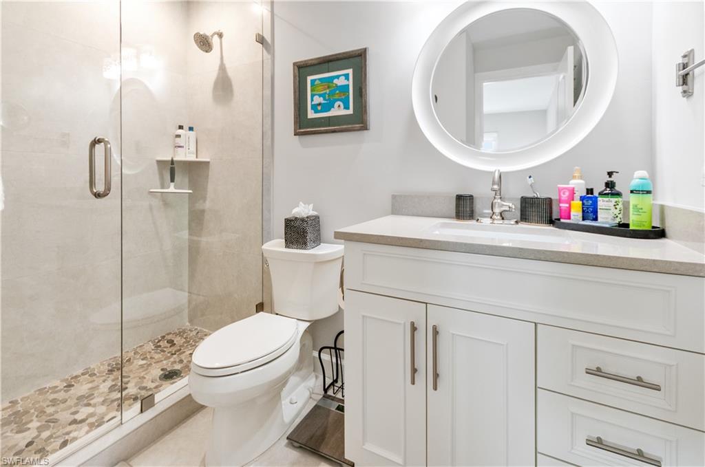 Bathroom featuring vanity and a shower stall