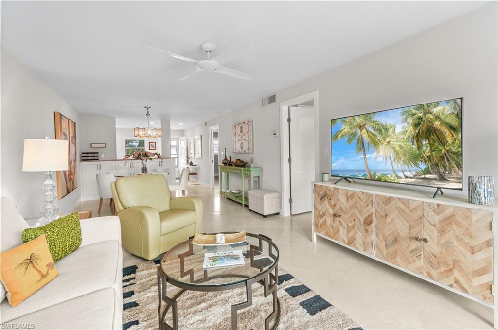 Living area featuring ceiling fan and light tile patterned flooring