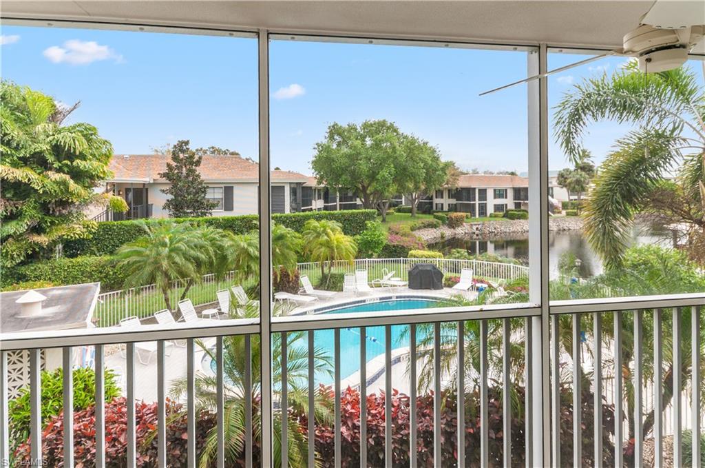 Community pool featuring a sunroom and a balcony