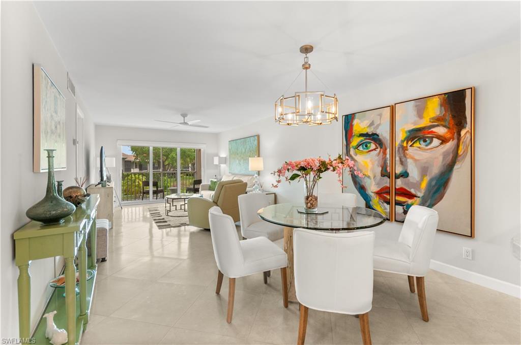 Dining room featuring suspended lighting, a ceiling fan, and light tile patterned floors