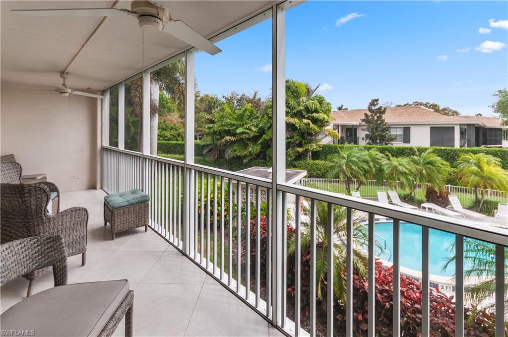 Balcony with view of pool and ceiling fan