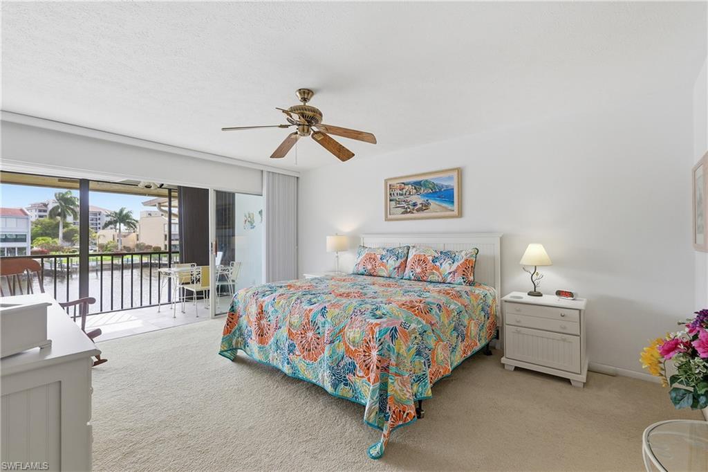 Bedroom featuring light carpet, access to outside, and a ceiling fan