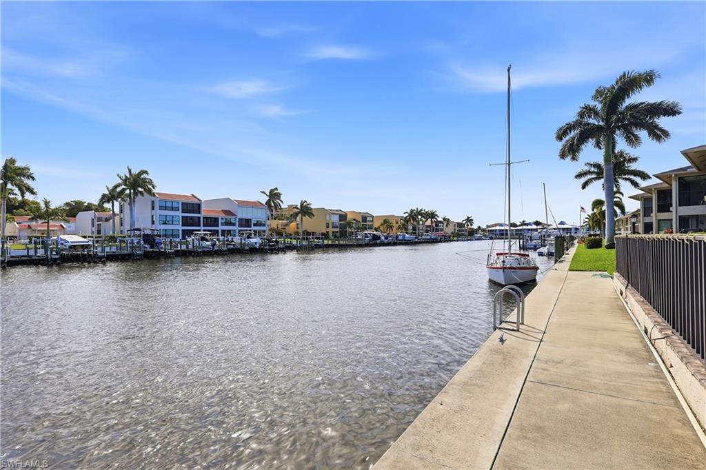 Dock area with a water view and a residential view