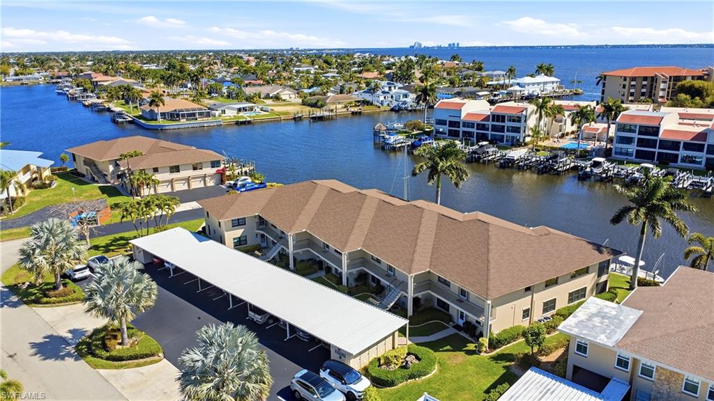 Aerial view of a nearby body of water and apartment complex / building