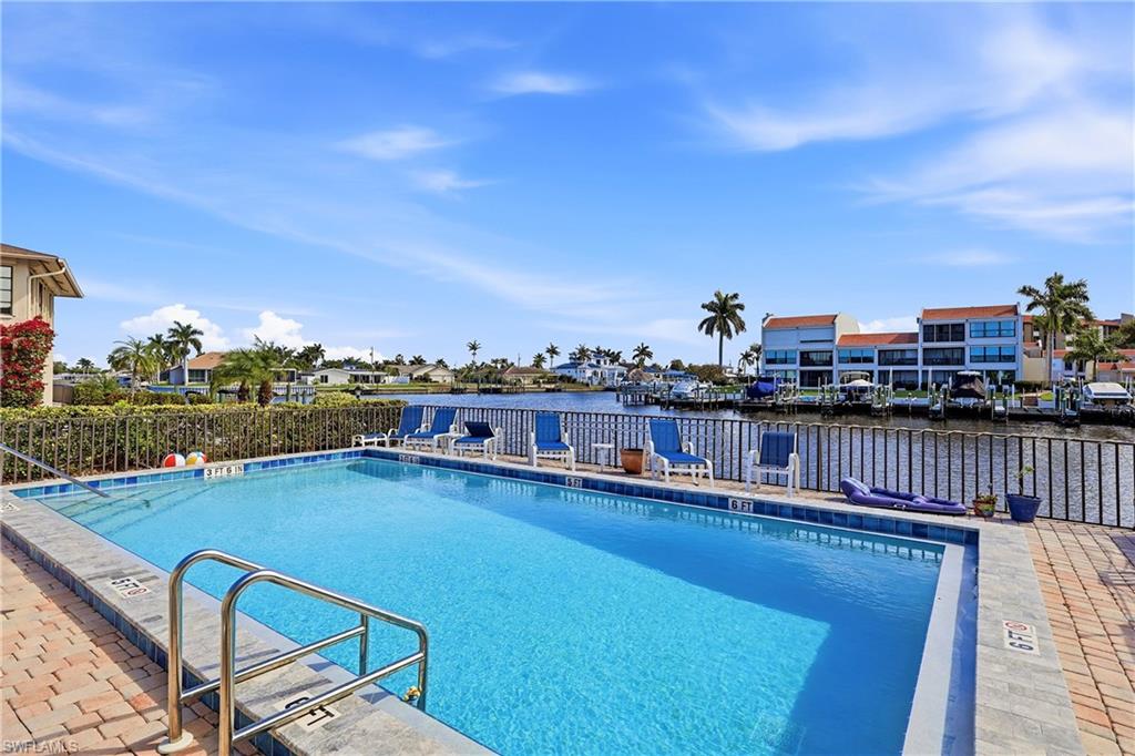 Community pool featuring a residential view and a patio