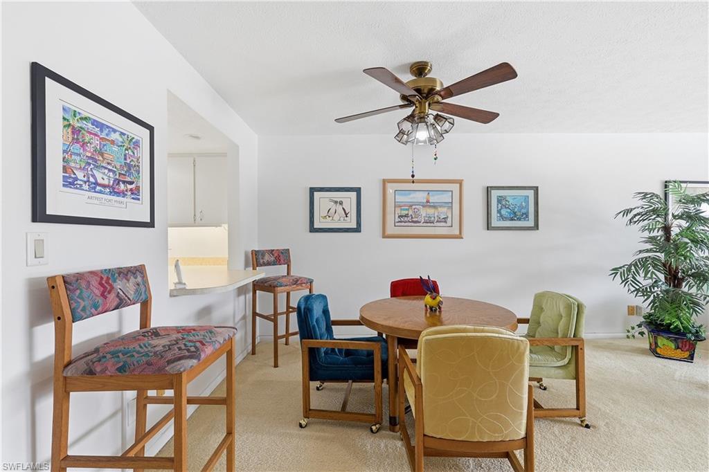 Dining area featuring light carpet and ceiling fan