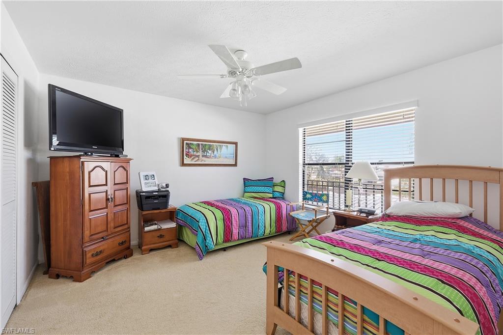 Bedroom with light carpet and ceiling fan