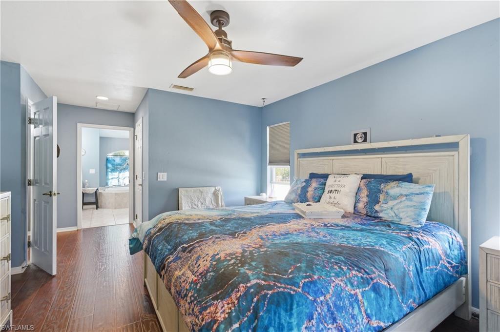 Bedroom featuring ceiling fan and dark wood-style floors