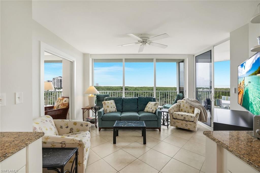 Sunroom with tile patterned flooring and floor to ceiling windows