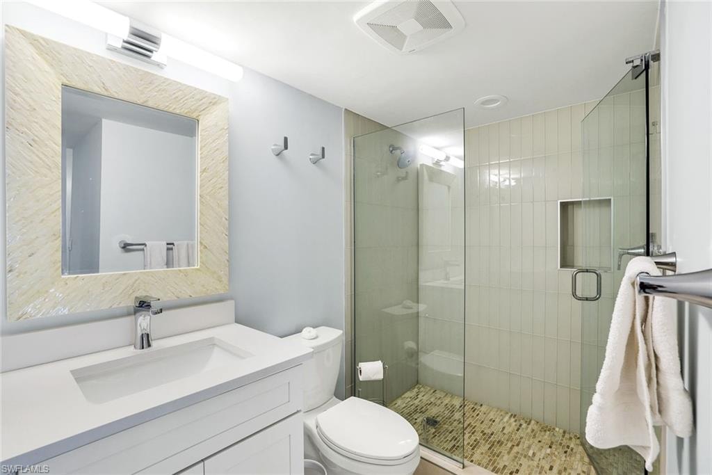 Full bathroom with vanity and a shower stall